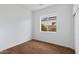 Bedroom featuring wood floors, white walls, and a window overlooking the yard at 721 W Cherrywood Dr, Chandler, AZ 85248