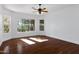 Bright bedroom features hardwood floors, modern ceiling fan, and sunlit window at 721 W Cherrywood Dr, Chandler, AZ 85248