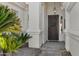 Elegant entryway with a decorative security door, stylish lighting, and well-maintained landscaping at 721 W Cherrywood Dr, Chandler, AZ 85248