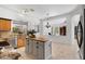 Open concept kitchen with island featuring granite counters, stainless steel appliances, and view into living area at 721 W Cherrywood Dr, Chandler, AZ 85248