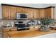Close-up of a well-appointed kitchen featuring granite counters, stainless steel microwave, and light wood cabinets at 721 W Cherrywood Dr, Chandler, AZ 85248