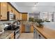 Bright kitchen featuring stainless steel appliances, granite countertops, light wood cabinets, and a large island at 721 W Cherrywood Dr, Chandler, AZ 85248