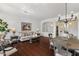 Bright living space with hardwood floors, a decorative chandelier, and a comfortable seating area at 721 W Cherrywood Dr, Chandler, AZ 85248