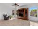 Bright and airy living room featuring neutral walls, a ceiling fan, and dark wood entertainment center at 721 W Cherrywood Dr, Chandler, AZ 85248