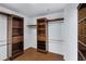 Spacious walk-in closet with custom wood shelving and ample storage for clothing and accessories at 721 W Cherrywood Dr, Chandler, AZ 85248