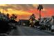 This property shows homes in the community during a beautiful dusk sunset with a well maintained street and landscaping at 7750 E Broadway Rd # 814, Mesa, AZ 85208