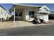 Exterior of a well-maintained home with a golf cart at 7750 E Broadway Rd # 814, Mesa, AZ 85208