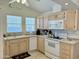This kitchen offers plenty of counter space, white appliances, and natural wood cabinets at 7750 E Broadway Rd # 814, Mesa, AZ 85208