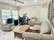 Cozy living room featuring a neutral color palette, plush seating, and a dedicated workspace at 7750 E Broadway Rd # 814, Mesa, AZ 85208