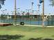 This property features a community tennis court surrounded by palm trees and well-maintained grass and landscaping at 7750 E Broadway Rd # 814, Mesa, AZ 85208