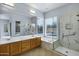 Spacious bathroom featuring a double sink vanity, soaking tub, glass shower, and large window at 890 W Oriole Way, Chandler, AZ 85286