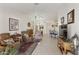 Inviting open-plan living room with tile floors, dining area, lots of light, and comfortable seating at 10318 E Spring Creek Rd, Sun Lakes, AZ 85248