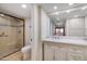 Bright bathroom with a glass enclosed shower, toilet, and modern vanity at 12222 N Paradise Village S Pkwy # 224, Phoenix, AZ 85032
