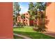 Exterior of a lush landscaped building with verdant green lawn and mature trees providing shade at 12222 N Paradise Village S Pkwy # 224, Phoenix, AZ 85032