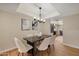 Inviting dining area with stylish furniture, a modern light fixture, and a view of the adjacent living spaces at 12222 N Paradise Village S Pkwy # 224, Phoenix, AZ 85032