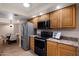 Lovely kitchen featuring wood cabinets and stainless steel appliances adjacent to a dining area at 12222 N Paradise Village S Pkwy # 224, Phoenix, AZ 85032