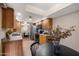 Well-lit kitchen with wood cabinetry and stainless steel appliances, with an adjacent dining area at 12222 N Paradise Village S Pkwy # 224, Phoenix, AZ 85032