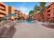 Beautiful community pool area with waterfall, lush trees, and plenty of lounge chairs for relaxation at 12222 N Paradise Village S Pkwy # 224, Phoenix, AZ 85032