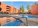 Inviting outdoor pool and spa with waterfall feature, surrounded by stylish architecture and lounge seating at 12222 N Paradise Village S Pkwy # 224, Phoenix, AZ 85032