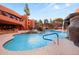 Stunning pool area with waterfall feature, blue skies, and comfortable lounge area at 12222 N Paradise Village S Pkwy # 224, Phoenix, AZ 85032