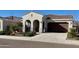 Inviting single-story stucco home with a tile roof, arched entryway, and a two-car garage at 12330 E Crystal Frst, Gold Canyon, AZ 85118