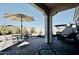 Covered patio featuring a stone tile floor, an umbrella-covered table, and outdoor furniture at 12330 E Crystal Frst, Gold Canyon, AZ 85118