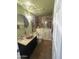 Well-lit bathroom with stone sink, a walk-in bathtub, and stone tile at 1302 E Tierra Buena Ln, Phoenix, AZ 85022