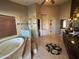 Primary bathroom featuring tiled floor, a soaking tub, a separate glass-enclosed shower, and dual vanities at 1302 E Tierra Buena Ln, Phoenix, AZ 85022
