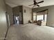 Bright bedroom with carpet, neutral walls, large window, and ceiling fan at 1302 E Tierra Buena Ln, Phoenix, AZ 85022