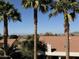 Palm tree framed views of community rooftops with mountain backdrop at 1302 E Tierra Buena Ln, Phoenix, AZ 85022