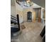 Inviting foyer features high ceilings, tile floors, a modern chandelier, and staircase at 1302 E Tierra Buena Ln, Phoenix, AZ 85022