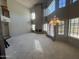 Spacious living room featuring large windows, high ceilings, neutral colors, and a fireplace at 1302 E Tierra Buena Ln, Phoenix, AZ 85022
