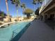 An exterior backyard pool featuring mature palm trees and desert landscaping at 1302 E Tierra Buena Ln, Phoenix, AZ 85022