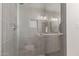 This shower features glass doors, chrome fixtures, and gray tile throughout at 1322 S Oracle --, Mesa, AZ 85204