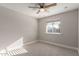 This bedroom is painted in a neutral color and has a window and ceiling fan at 1322 S Oracle --, Mesa, AZ 85204