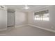 This bedroom features neutral carpet, a ceiling fan, large window, and a closet for optimal storage at 1322 S Oracle --, Mesa, AZ 85204