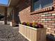 Up-close view of charming flower boxes adding character to the brick home's exterior at 1322 S Oracle --, Mesa, AZ 85204