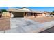 A single-story brick home with a covered carport with gravel landscaping and a spacious driveway at 1322 S Oracle --, Mesa, AZ 85204