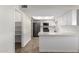Bright kitchen with a pantry, white cabinets, subway tile backsplash, and stainless appliances at 1322 S Oracle --, Mesa, AZ 85204