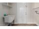 Bright laundry room with utility sink, white cabinets, and vinyl flooring at 1322 S Oracle --, Mesa, AZ 85204