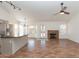 Spacious living room featuring tile flooring, a fireplace, and a view of the kitchen with bar seating at 13319 W Virginia Ave, Goodyear, AZ 85395