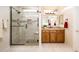 The lovely bathroom is equipped with a glass-enclosed shower, a tile backsplash, and a modern vanity at 13434 W El Sueno Ct, Sun City West, AZ 85375