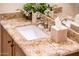 Bathroom vanity featuring granite countertop, stylish fixtures, and decorative accents at 13434 W El Sueno Ct, Sun City West, AZ 85375