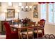 Elegant dining room featuring a wooden table, chandelier, and bright windows at 13434 W El Sueno Ct, Sun City West, AZ 85375