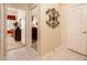 A hallway with tile floors peers into a living room, and features intricate metal wall decor at 13434 W El Sueno Ct, Sun City West, AZ 85375