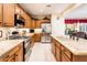 Bright kitchen featuring granite countertops, stainless steel appliances, and ample counter space at 13434 W El Sueno Ct, Sun City West, AZ 85375