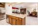 Open kitchen with granite countertops, stainless appliances, and seamless flow to living areas at 13434 W El Sueno Ct, Sun City West, AZ 85375