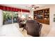 Cozy living room with plush seating, built-in shelving, and sliding door to the backyard at 13434 W El Sueno Ct, Sun City West, AZ 85375
