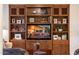 Entertainment center with books, photos and display shelving at 13434 W El Sueno Ct, Sun City West, AZ 85375