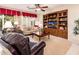 Comfortable living room featuring plush seating, a built-in entertainment center, and natural light at 13434 W El Sueno Ct, Sun City West, AZ 85375